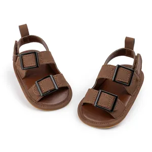 Detailed top view of brown baby sandals with rubber soles and double buckle fasteners