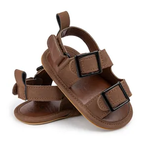 Close-up of brown baby sandals with buckle straps and soft rubber soles for summer