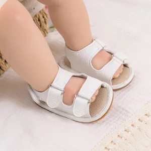 Close-up of white PU baby sandals with breathable soft soles and adjustable velcro straps