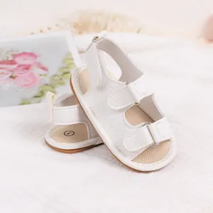 Detail of white PU baby sandals with dual velcro straps and soft non-slip soles