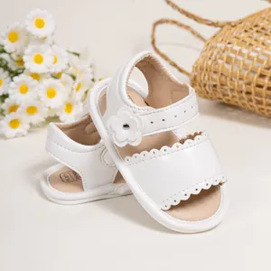 White flower baby sandals with cutout details and scalloped edges for summer toddlers