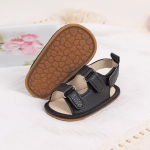 Close-up of black PU leather baby sandals with anti-slip rubber soles and velcro straps