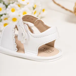 White baby girl sandals with floral lace details and velcro straps for 0-6 months