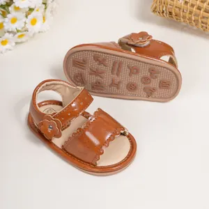 Brown faux leather baby sandals with floral accents and non-slip zodiac embossed soles