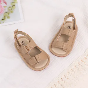 Macro detail of brown PU leather baby sandals featuring velcro straps and soft fabric insoles