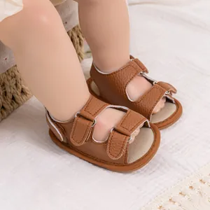 Detail of brown PU leather baby sandals with lychee texture and hook-and-loop straps