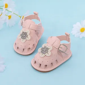 Detailed top view of pink baby girl sandals with 3D flower decor and protective toe cap