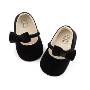 Détail de chaussures bébé en velours noir avec semelles souples et élastique pour 0-6 mois