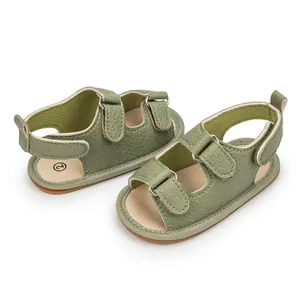 Detail of olive green baby sandals with textured faux leather and velcro straps