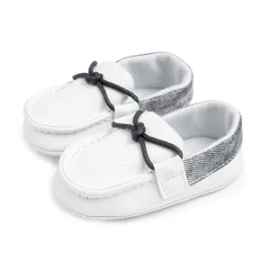 Detailansicht der Baby-Slipper mit atmungsaktivem weißem Leder und grauen Denim-Akzenten