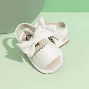 White faux leather baby sandals with large bow decoration and non-slip soft sole