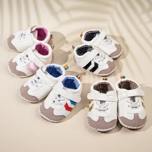 Detail view of baby walker shoes in multiple colors with soft PU soles and rainbow heel tabs