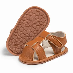 Detail of dark brown baby sandals showing the non-slip soft sole and Velcro strap
