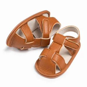 Brown infant leather sandals with closed toe design and adjustable velcro straps