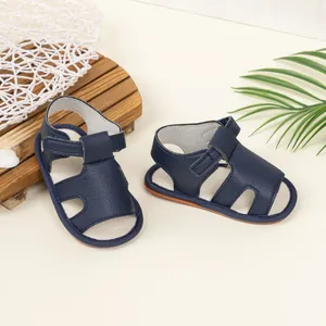 Detail of navy blue baby sandals with velcro strap and soft sole for early walkers