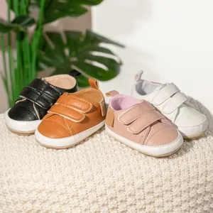 Close-up of baby walking shoes with non-slip rubber soles and double velcro straps