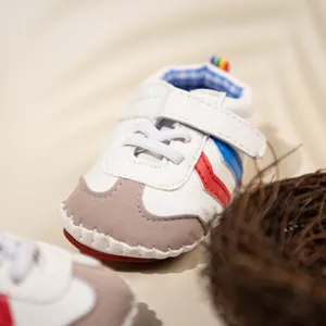 Detail of infant walking shoe featuring velcro strap and soft leather texture