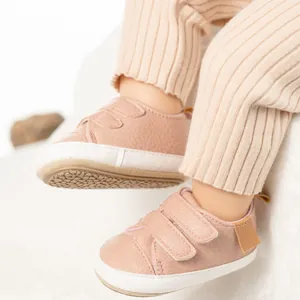 Close-up of pink baby shoes with double Velcro straps and non-slip rubber soles