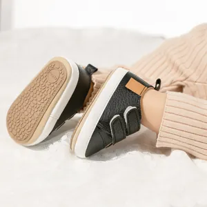 Detail view of baby walking shoe with double velcro straps and anti-slip rubber sole
