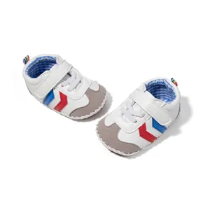 Classic white and grey baby walking shoes with blue and red stripes and Velcro straps