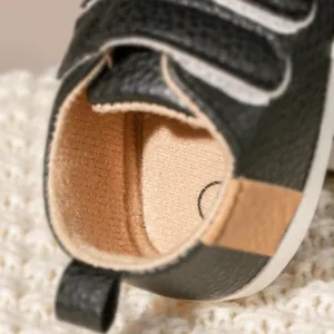 Macro detail of baby walking shoes with soft brown fleece lining and black leather pull tab