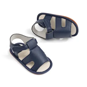 Detailed view of navy blue baby sandals with hook-and-loop straps and textured leather