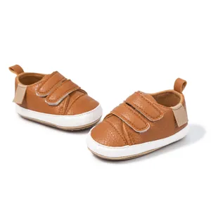 Close-up of brown baby walking shoes with double hook-and-loop fasteners and white soles