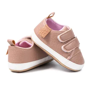 Detail view of pink baby sneakers with anti-slip rubber soles and double velcro straps
