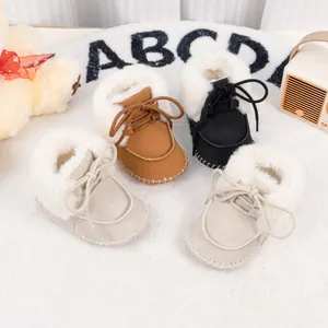 Detail of warm baby winter boots with soft faux fur lining and lace-up closure design