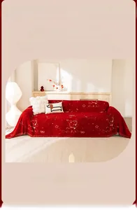 Close-up of red chenille sofa cover featuring golden cartoon dog and star patterns