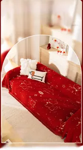 Detail of red French cream sofa cover with golden puppy embroidery and fringe trim