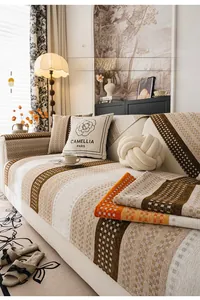 Detail of skin-friendly chenille sofa cover with orange and brown geometric patterns