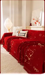 Detail of red cartoon teddy bear sofa cover with fringed edges and star patterns