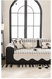 Detailed scalloped edges and tassels on chenille sofa cover with striped pattern