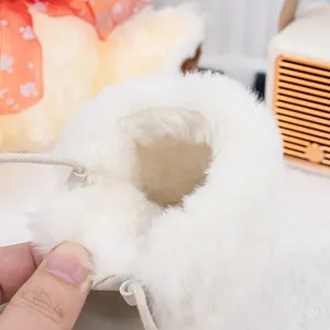 Detailed macro view of the thick white faux fur lining inside the warm baby winter boot