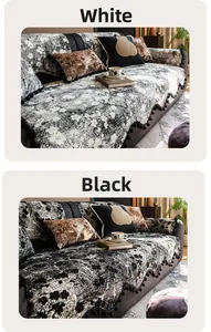 Detail of chenille sofa cover with floral patterns and black pom-pom fringe edges