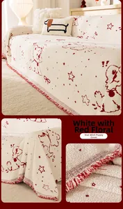 Detail of white sofa cover with red puppy patterns and decorative fringe trim