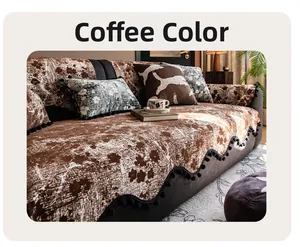 Detail of coffee brown chenille sofa cover with floral texture and black pom-pom fringe
