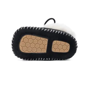 Detailed view of baby winter boots featuring non-slip rubber soles and warm wool lining