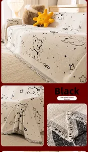 Detail of star puppy pattern on beige chenille sofa cover with fringed edges