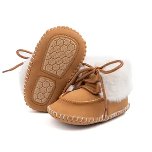 Detail of baby winter boots showing anti-slip honeycomb rubber sole and warm faux fur lining