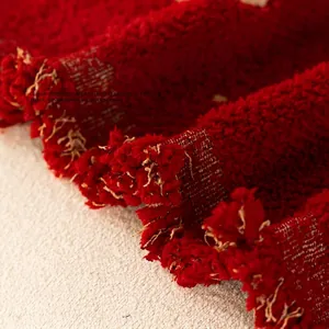 Deep red three-dimensional jacquard sofa cover with stylish houndstooth pattern and tassels