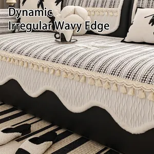French chenille sofa cover with wavy edges and decorative tassels in a cozy Nordic style