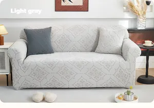 Close-up of light gray stretch sofa cover with geometric jacquard pattern and pillow cases