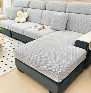 Close-up of grey and white herringbone stretch chenille fabric on a modular sofa