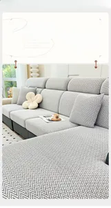 Detail of grey chenille sofa cover showing thick herringbone texture and soft fabric