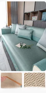 Detail of ice silk sofa mat showing non-slip backing, elastic straps, and floral embroidery