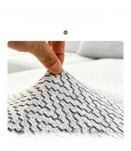 Detail of high-elasticity chenille sofa cover with wavy pattern showing stretchable fabric