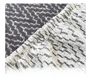Detail of chenille sofa cover with geometric wave texture and reinforced elastic edging