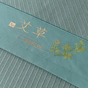 Green wormwood cooling sofa mat with premium embroidery and durable woven texture